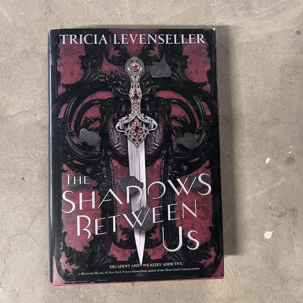 The Shadows Between Us Hardcover Book